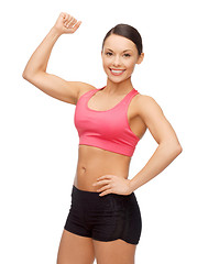 Image showing asian sporty woman flexing her biceps