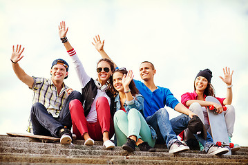 Image showing group of teenagers waving hands