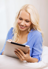 Image showing smiling woman with tablet pc computer at home