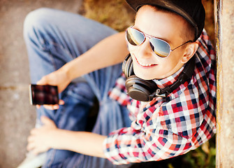 Image showing girl with headphones and smartphone