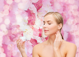 Image showing woman applying cream on her skin