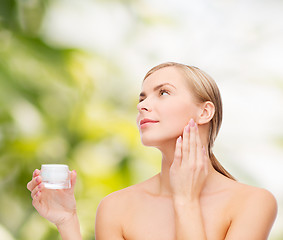 Image showing woman applying cream on her skin