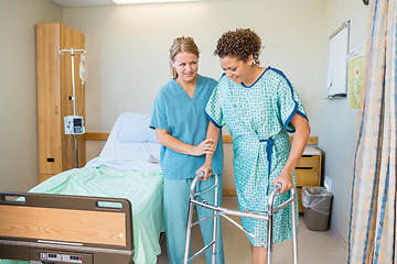 Image showing Nurse Helping Patient To Walk Using Walker In Hospital