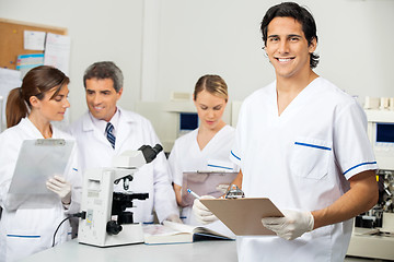 Image showing Male Scientist Holding Clipboard In Lab