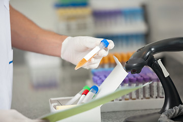 Image showing Technician With Sample Analyzing Document In Laboratory