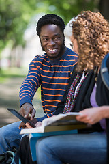 Image showing Student Using Digital Tablet With Friends On Campus