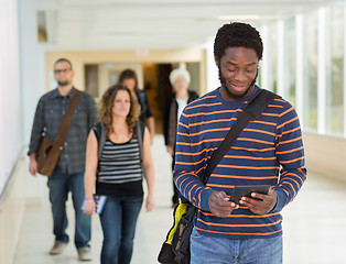 Image showing Student Using Digital Tablet Down University Corridor