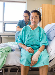 Image showing Nurse Examining Patient's Back With Stethoscope On Hospital Bed