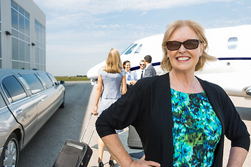 Image showing Happy Businesswoman Against Private Jet