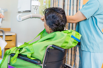 Image showing Nurse Holding Hydraulic Lift's Handle With Patient On Wheelchair