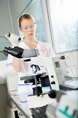 Image showing Scientist Filling Liquid Into Test Tube In Lab