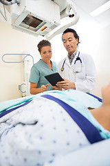 Image showing Medical Team Using Digital Tablet In Examination Room