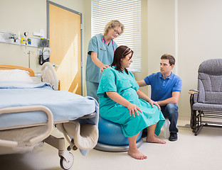 Image showing Nurse And Man Assisting Pregnant Woman On Exercise Ball