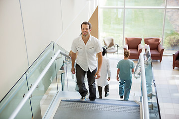 Image showing Patient And Medical Team Walking On Stairs In Hospital