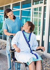 Image showing Patient Looking At Friendly Nurse While Sitting On Wheelchair