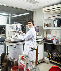 Image showing Scientist Analyzing Urine Samples In Laboratory