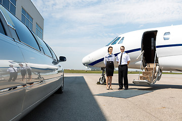 Image showing Flight Attendant And Pilot Neat Limousine And Private Jet