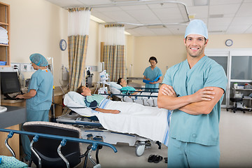 Image showing Nurse With Colleagues And Patient's In Hospital Ward