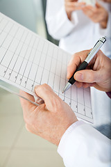 Image showing Researcher Writing On Clipboard