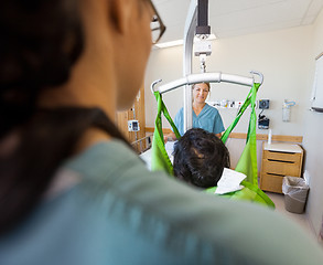 Image showing Nurse Smiling With Patient On Hydraulic Lift