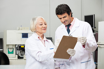 Image showing Scientists Writing On Clipboard In Laboratory