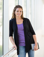 Image showing Confident Student Holding Digital Tablet At University Corridor