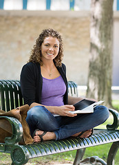 Image showing Portrait Of Happy Student Studying On Bench