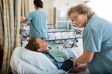 Image showing Nurse Checking Patient's Blood Pressure