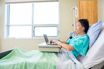 Image showing Patient Using Laptop On Hospital Bed