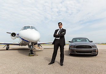 Image showing Businessman Standing By Car And Private Jet At Terminal