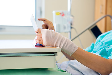 Image showing Patient Using Tablet Computer While Relaxing In Hospital