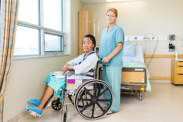 Image showing Patient On Wheel Chair While Nurse Standing Behind At Window