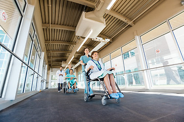 Image showing Nurses Pushing Patients On Wheelchairs At Hospital Corridor