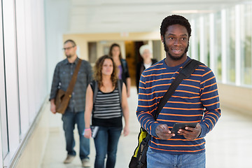 Image showing Student Using Digital Tablet Down University Corridor