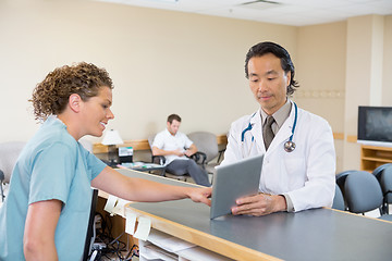 Image showing Doctor And Nurse Using Digital Tablet At Reception