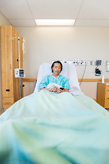 Image showing Patient Messaging Through Mobile Phone On Hospital Bed