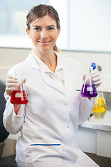 Image showing Scientist Examining Flasks With Different Chemicals