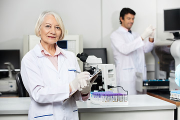 Image showing Female Scientist Writing On Clipboard In Laboratory