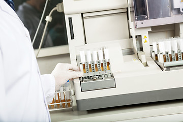 Image showing Technician Using Urine Analyzer In Lab