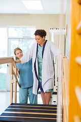 Image showing Patient Being Assisted By Physical Therapist In Moving Upstairs