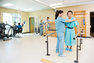 Image showing Therapists Assisting Patients In Hospital Gym