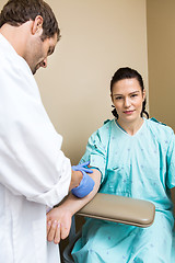 Image showing Patient With Doctor Drawing Blood From Her Arm