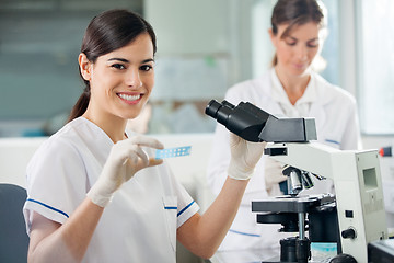 Image showing Female Researcher Using Microscope In Lab