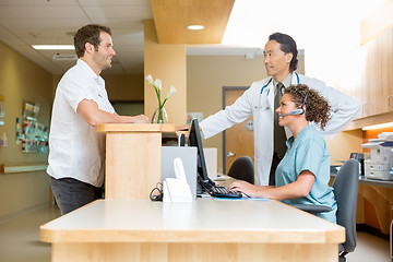 Image showing Patient With Doctor And Nurse At Reception Desk