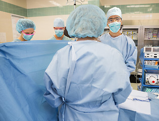 Image showing Doctor With Team Operating Patient