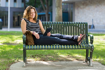 Image showing Female University Student Using Digital Tablet On Bench