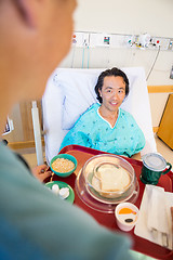 Image showing Smiling Patient Looking At Nurse Serving Breakfast