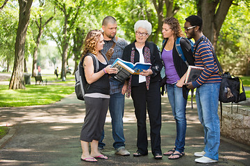 Image showing Students Discussing Notes On Campus Road