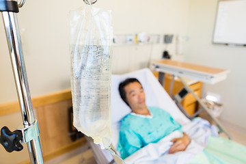 Image showing IV Bag With Patient Lying On Hospital Bed