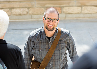 Image showing Smiling Male Student With Bag Standing On Campus